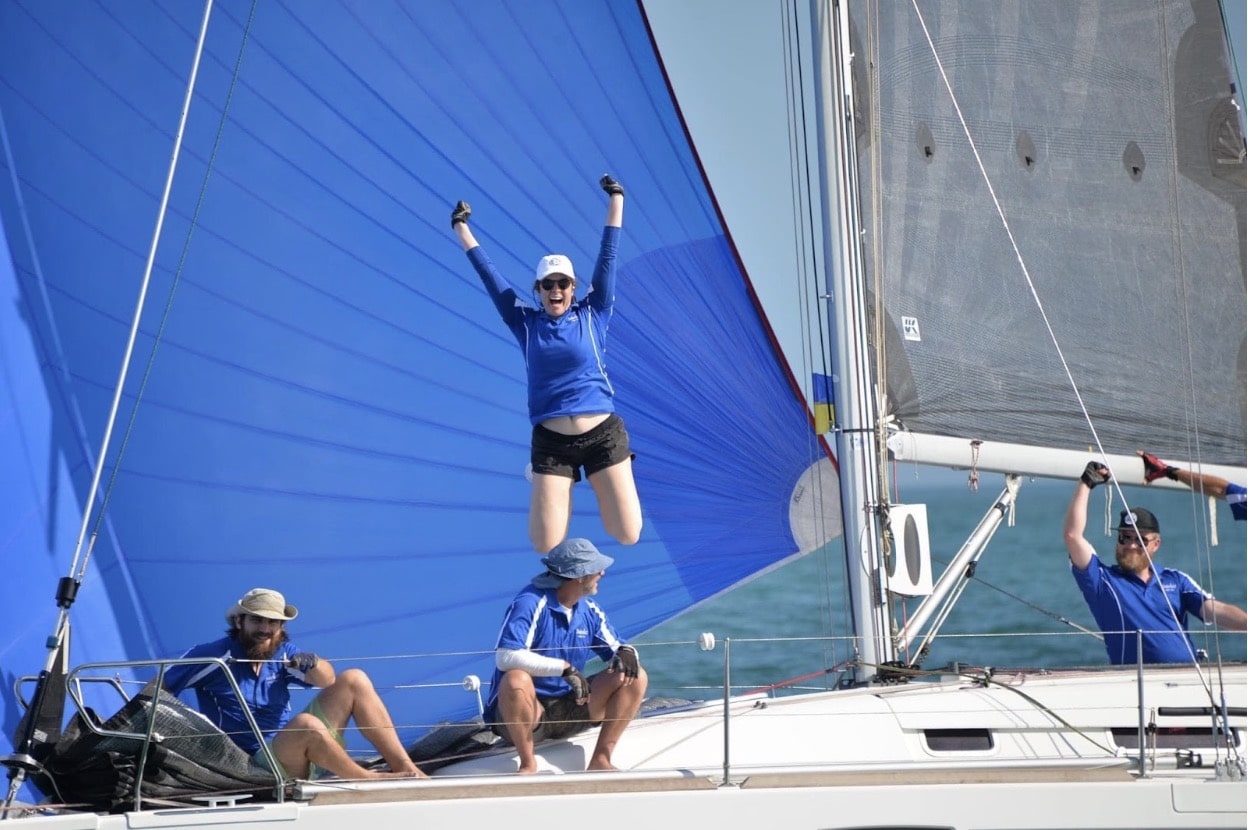 Foredeck, Victoria Willetts, jumps for joy as Steve Delfos’ Beneteau First 30, MINKE, crosses the finish line ahead of the fleet at the Fremantle Sailing Club’s Opening Day Race. Photo Credit: Chris Bender