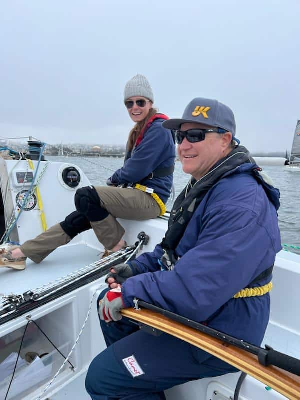 Brendan Huffman smiling at the hem of his boat Siren.