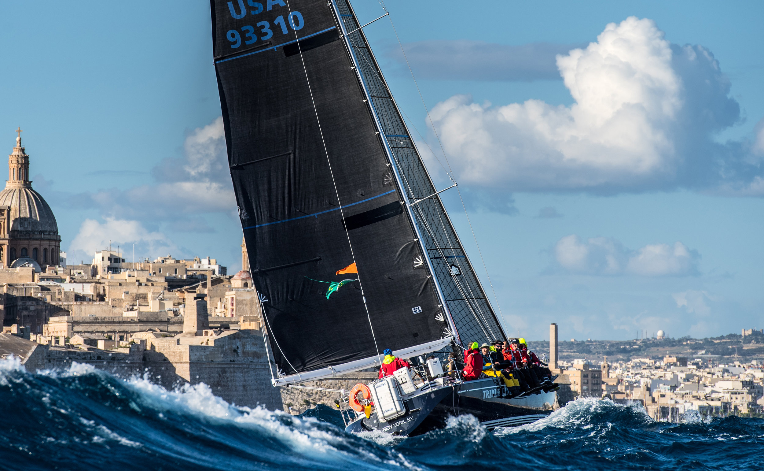 Photo of TRIPLE LINDY finishing the 2017 Rolex Middle Sea Race courtesy of Rolex/Kurt Arrigo.