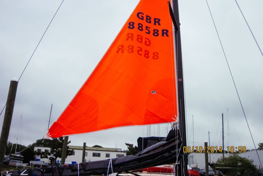 The “droopy clew” of the trysail allows the tack to be raised above the stack of mainsail luff cars when the sail is left on the boom.